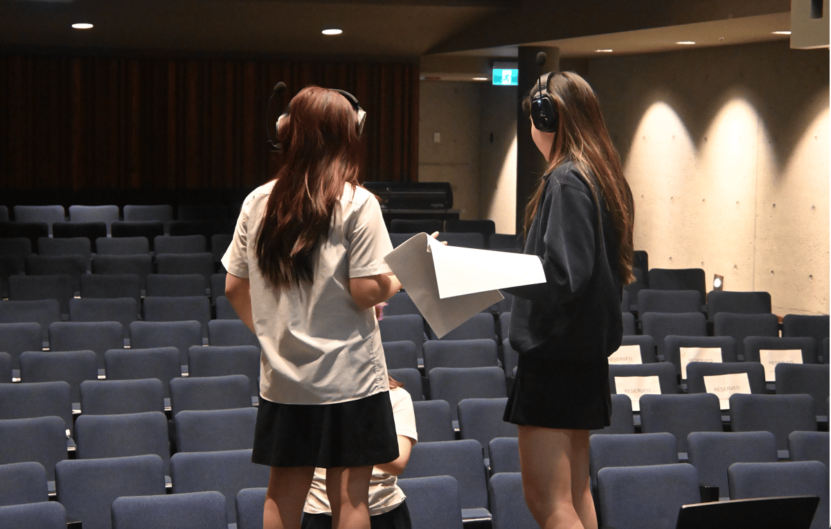 Sarah working in an auditorium